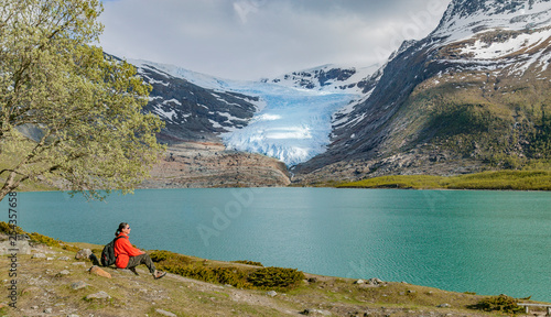 senior woman hike along north Fjord in front of Svartisen glacier, northern Norway, Scandinavia photo