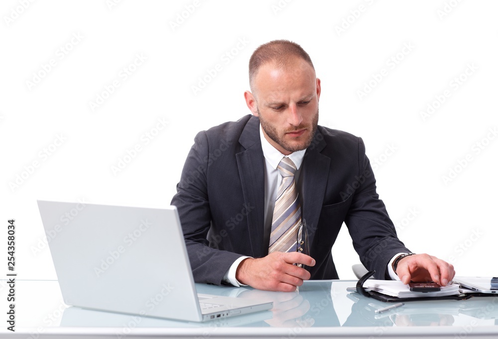 Businessman sitting at desk having laptop Businessman sitting at desk having laptop