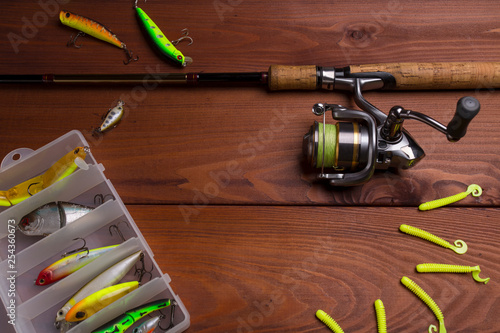 Fishing tackle wooden background. Equipment for spinning fishing.