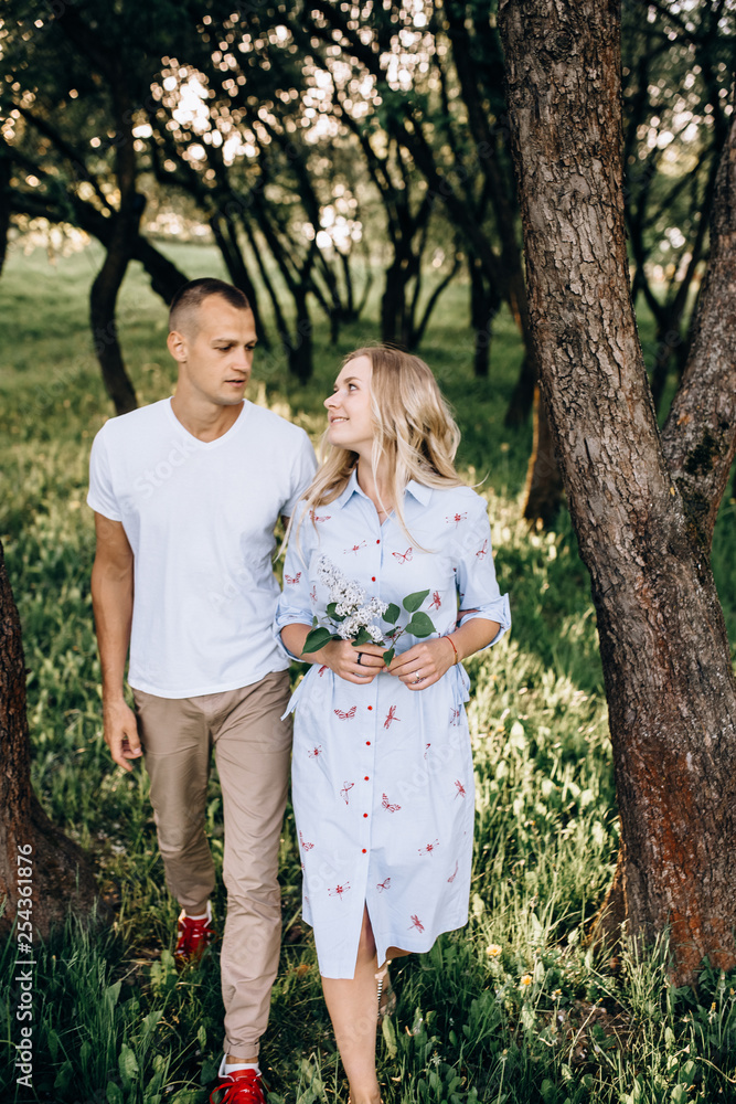 Fototapeta premium Happy young couple in love hugging enjoys spring day, loving carefree together outdoors walking at park