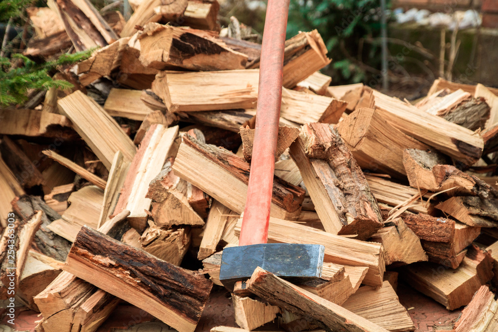 cleaver on the bunch of chopped firewoods cleaver on the bunch of chopped firewoods