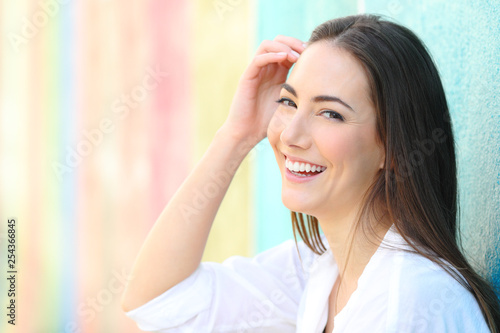 Happy woman with perfect smile in a colorful background