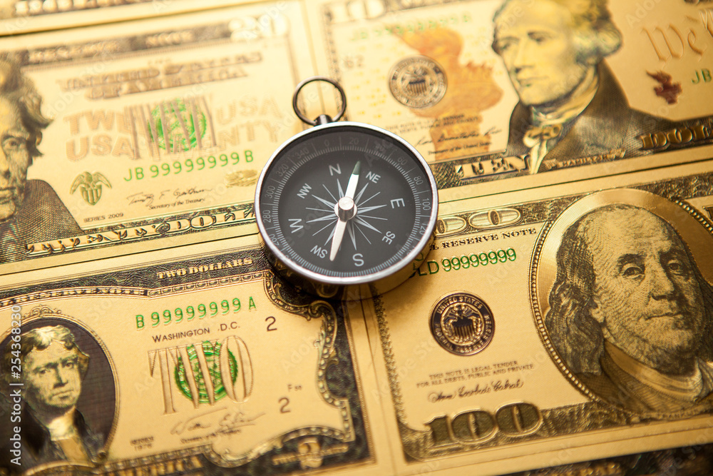 Dollars and compass. Concept on a financial theme. Dollars and compass. Concept on a financial theme.