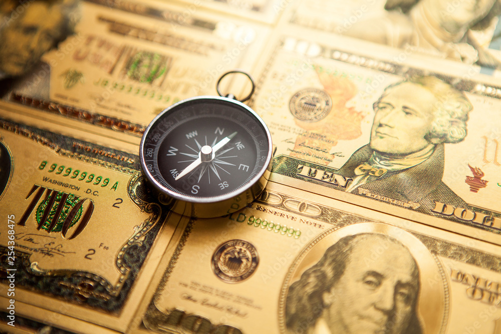 Dollars and compass. Concept on a financial theme. Dollars and compass. Concept on a financial theme.