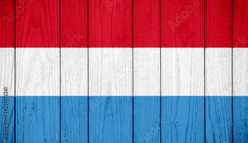 Flag of Luxembourg on wooden background
