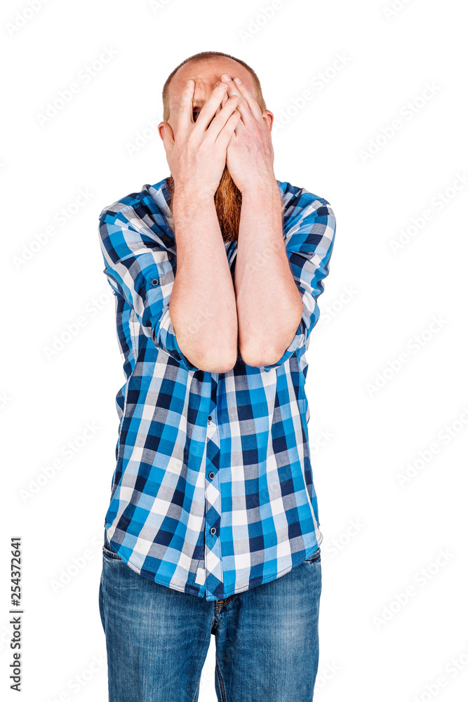 Portrait of bearded man covering her eyes with hands over gray background. Portrait of bearded man covering her eyes with hands over gray background.