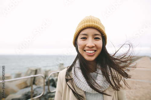 Portrait of a smiling asian woman in winter clothes