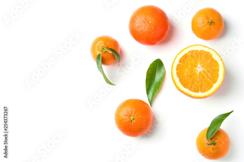 Bunch of ripe juicy organic oranges tangerines on branch with green leaves on white background. Top view flat lay. Vitamins healthy lifestyle vegan superfoods concept. Creative food poster banner