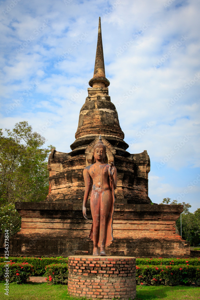 Obraz premium Pagoda and the buddha statue. in Old Buddhist temple in Sukhothai historical park In Thailand., Tourism, World Heritage Site, Civilization,UNESCO.