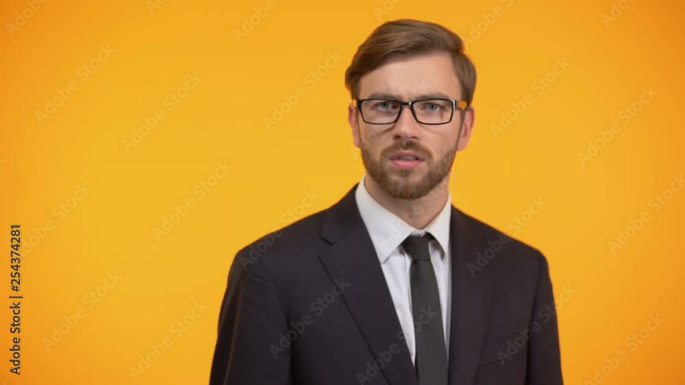 Serious male showing silence gesture, nondisclosure of personal data, secret Serious male showing silence gesture, nondisclosure of personal data, secret