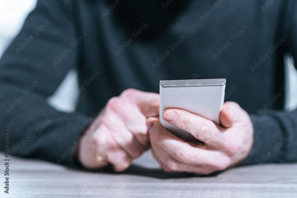 Male hands using a smartphone Male hands using a smartphone