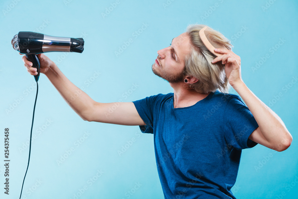 Trendy man with hair dryer Trendy man with hair dryer
