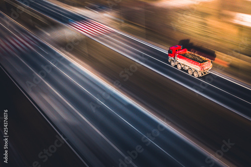 Fast tipper red truck - panning by drone