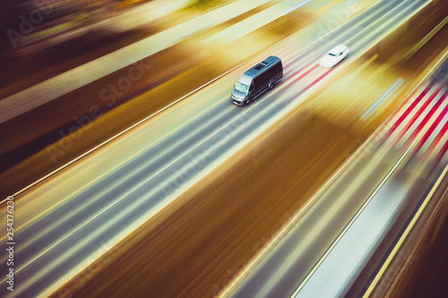 Billede på lærred Fast silver van passenger car - panning by drone