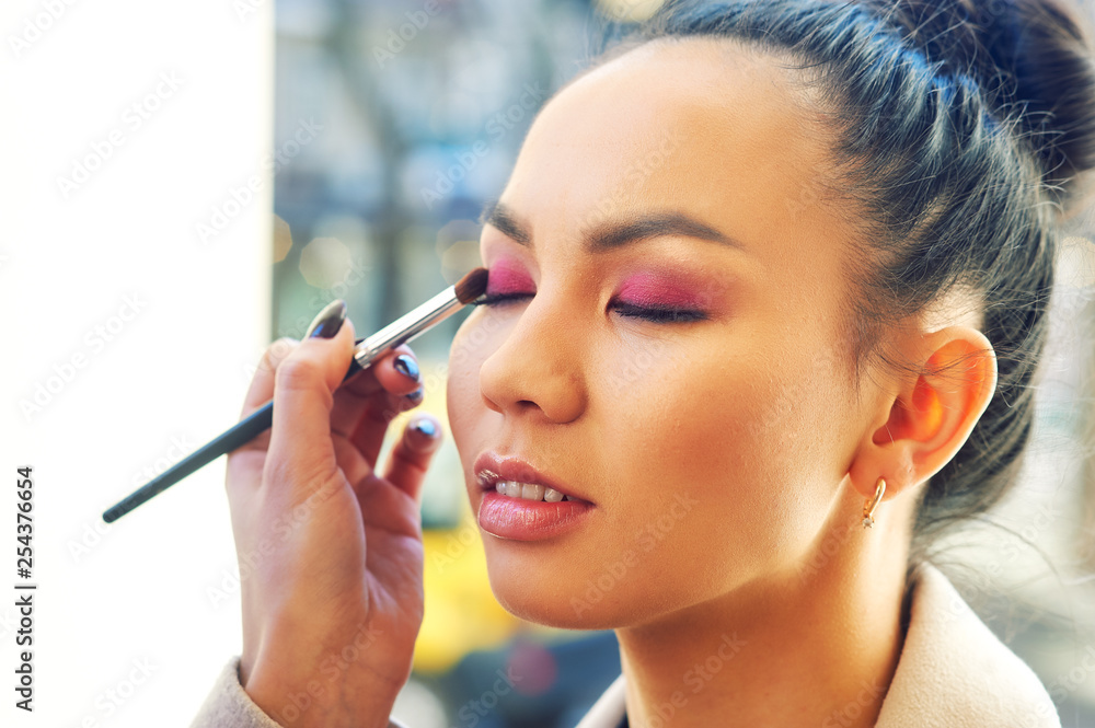 Make-up artist doing models makeup on the street Make-up artist doing models makeup on the street