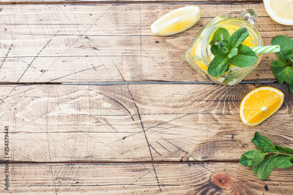 Lemonade drink of soda water, lemon and mint leaves in jar on wooden background. Copy space Lemonade drink of soda water, lemon and mint leaves in jar on wooden background. Copy space