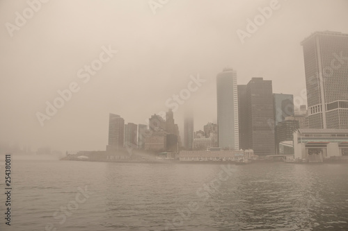 USA. New York City. Manhattan early in the morning. Thick fog. Embankment and skyscrapers.