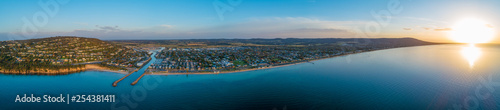 Wide aerial panorama of Mornington Peninsula coastline and luxury real estate at sunset
