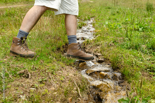 Hiker's leather shoe while crossing a brook