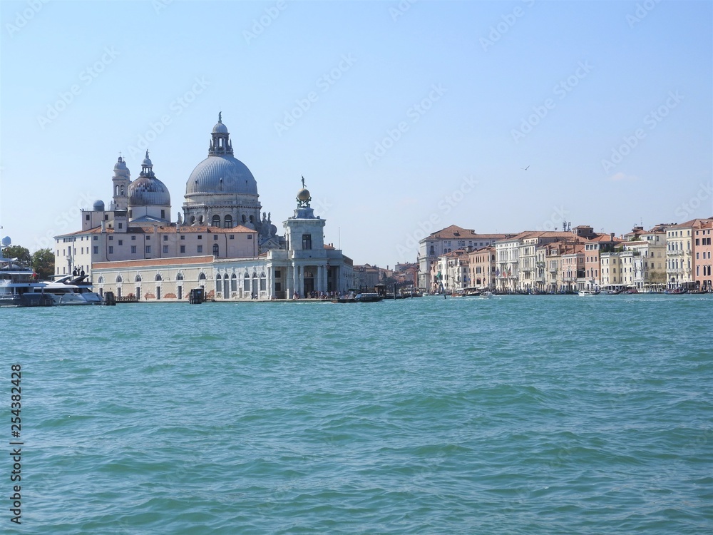 Summer day view from the water to the Venetian lagoon with the Basilica of Santa Maria della Salute in Venice, Italy.