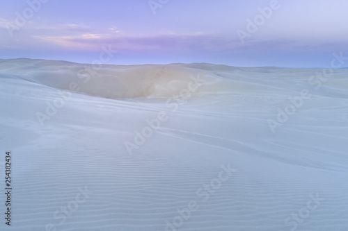 Pristine white sand dunes at dawn with copy space