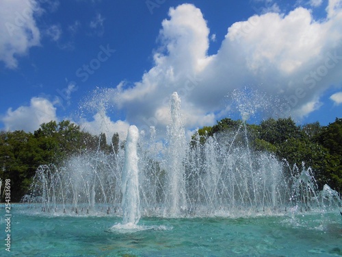 Fountain in the park with blue sky with clouds.