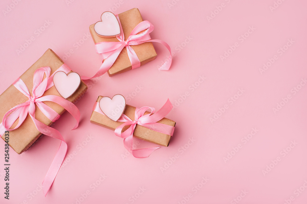 Valentine day composition: white gift boxes with bow and pink hearts. Top View. View from above. Valentine day composition: white gift boxes with bow and pink hearts. Top View. View from above.