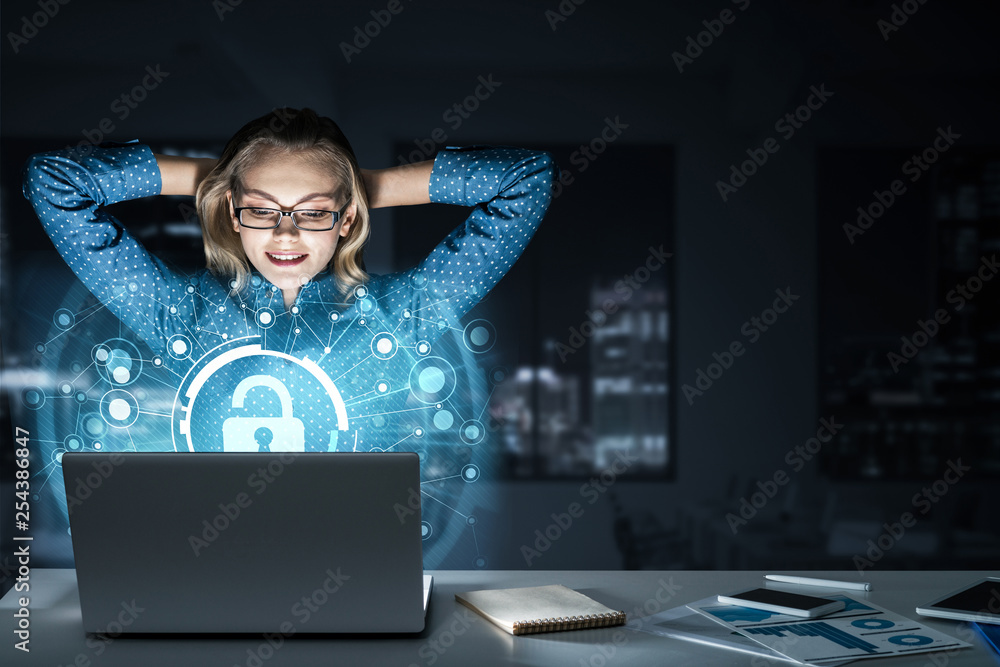 Beautiful blonde in dark office working on laptop and getting net access Beautiful blonde in dark office working on laptop and getting net access