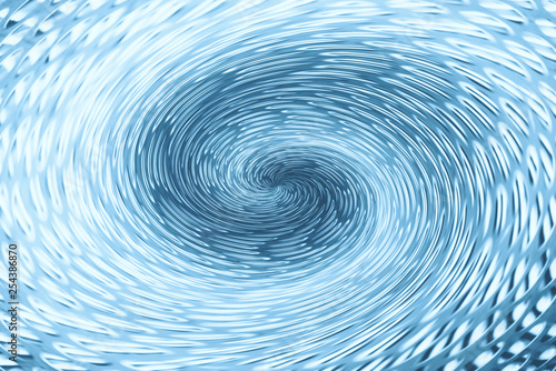 Blue wormhole in form of spiral absorbs space. Background image of asymmetric vortex tunnel in center of shot.