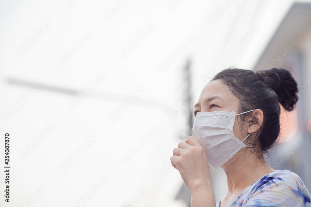 women wearing facial hygienic mask for Safety outdoor. People in masks because of fine dust in thailand. Problems found in major cities around the world. air pollution,Environmental awareness concept women wearing facial hygienic mask for Safety outdoor. People in masks because of fine dust in thailand. Problems found in major cities around the world. air pollution,Environmental awareness concept