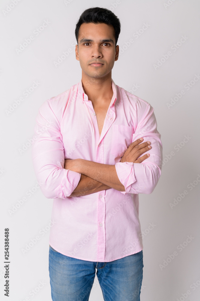 Portrait of young handsome Indian businessman with arms crossed Portrait of young handsome Indian businessman with arms crossed