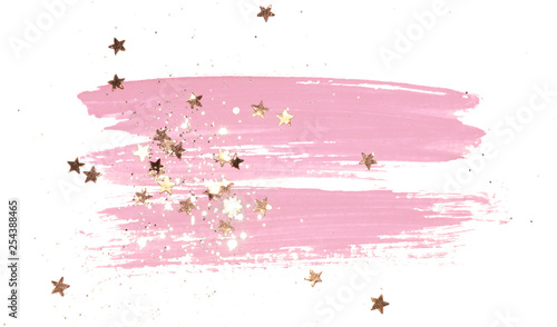 Golden glitter and glittering stars on abstract pink watercolor splash on white background