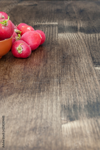 Top view of radishes  on wooden background