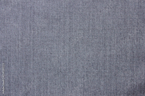 Grey texture background of seamless empty fabric design. Casual clothes close up top view of crumbled gray material cloth piece. Fashion backdrop for copy space or template