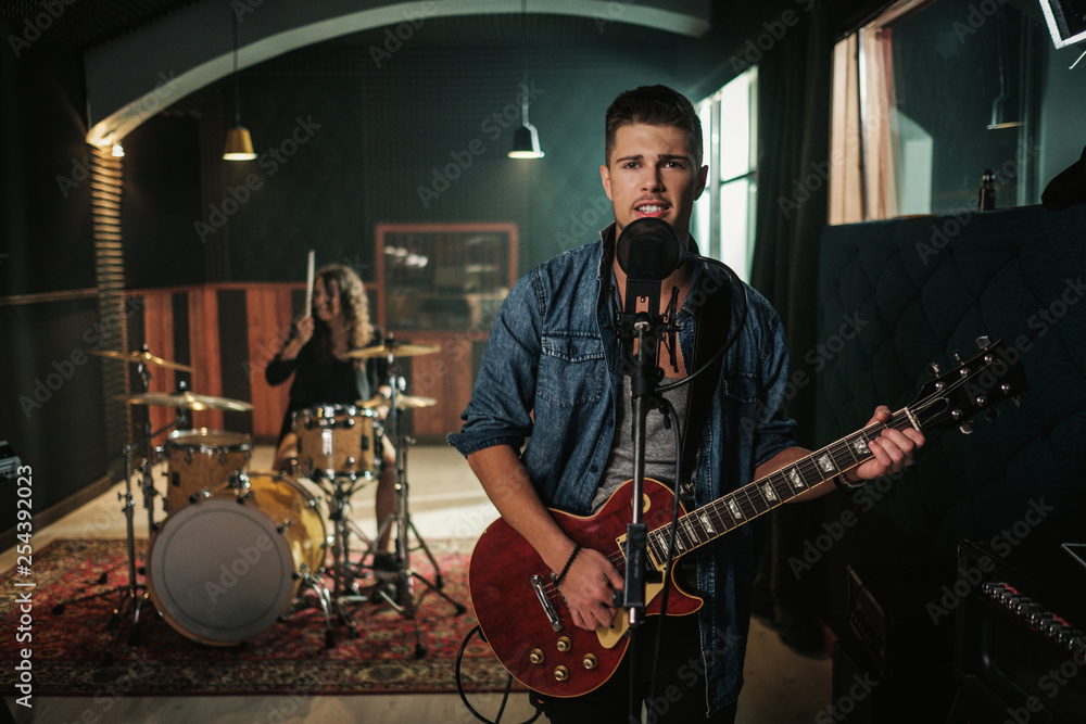 Fototapeta premium Music band having rehearsal in a studio