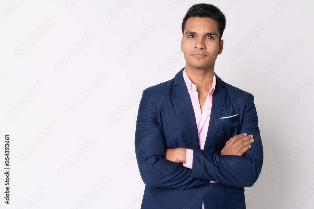 Portrait of young handsome Indian businessman in suit with arms crossed Portrait of young handsome Indian businessman in suit with arms crossed