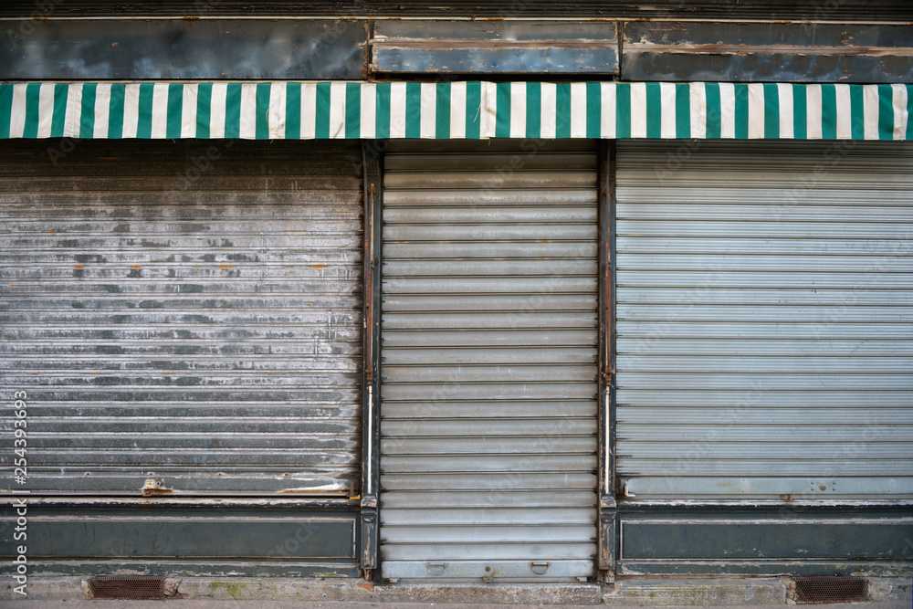 Old store. Ancient storefront with metallic closed curtains. Abandoned shop  business. Stock Photo | Adobe Stock