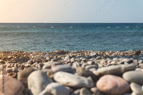 Pebbles on the shore and the sea horizon