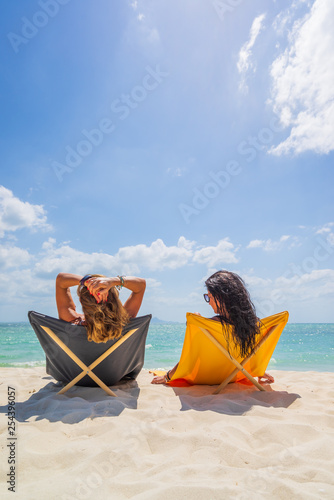 Two Women enjoying their holidays on the tropical beach