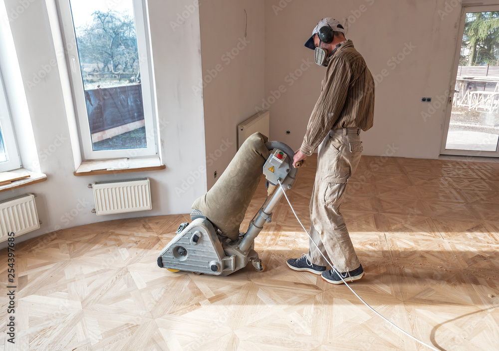 professional master grinding a parquet with machine - obrazy, fototapety, plakaty 