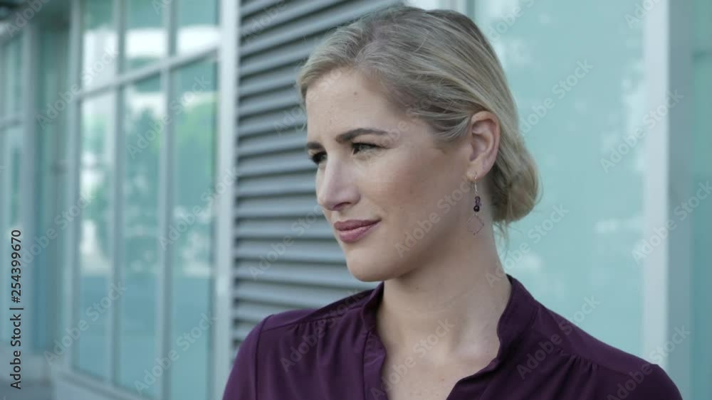 Young woman looks into camera with a serious face. Young woman looks into camera with a serious face.