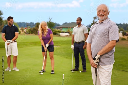 Portrait of active senior on the golf course photo