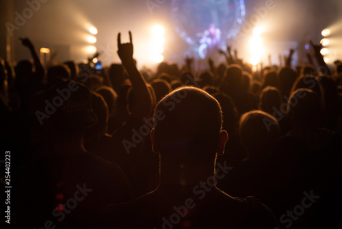 The audience with their hands on a rock concert.