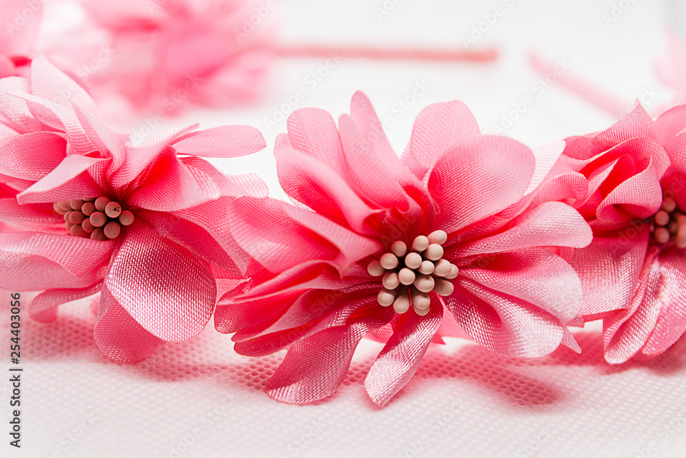 Baby hair accessory with pink flowers on white background Baby hair accessory with pink flowers on white background
