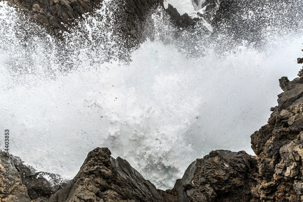 Beautiful view of the big waves crashing at the shore at Porto Moniz, on the north coast of Madeira island Beautiful view of the big waves crashing at the shore at Porto Moniz, on the north coast of Madeira island