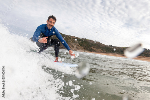 surfer having fun catching a wave and greeting