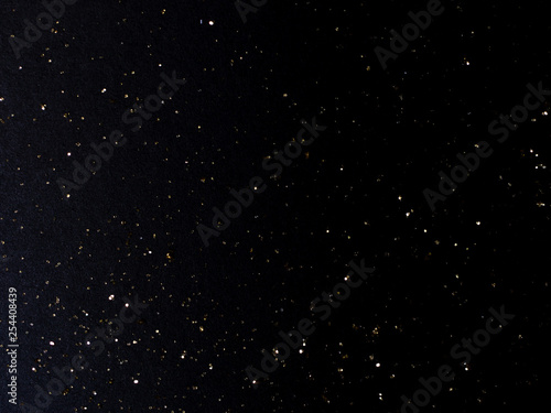 balck background with goolden stardust photo