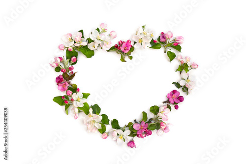 Frame of flowers apple tree in the shape heart on white background with space for text. Top view, flat lay