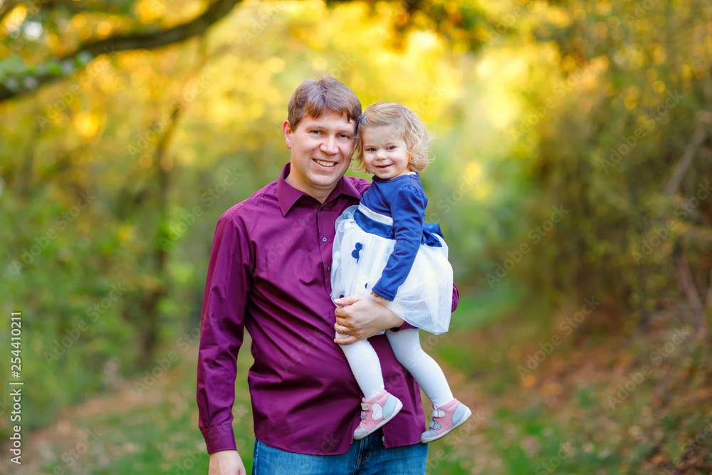 Happy young father having fun cute toddler daughter, family portrait together. man with beautiful baby girl in nature and forest. Dad with little child outdoors, hugging. Love, bonding. Happy young father having fun cute toddler daughter, family portrait together. man with beautiful baby girl in nature and forest. Dad with little child outdoors, hugging. Love, bonding.