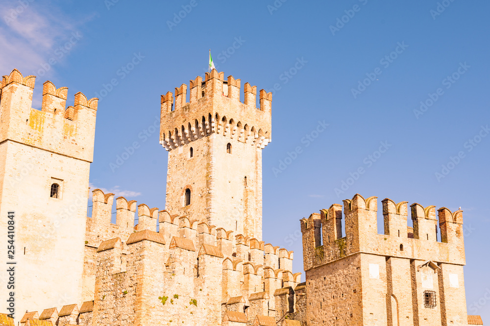 Castle in the north of Italy near the lake. Ancient castle and blue sky. Travel in Europe and tourism. Free space for text.